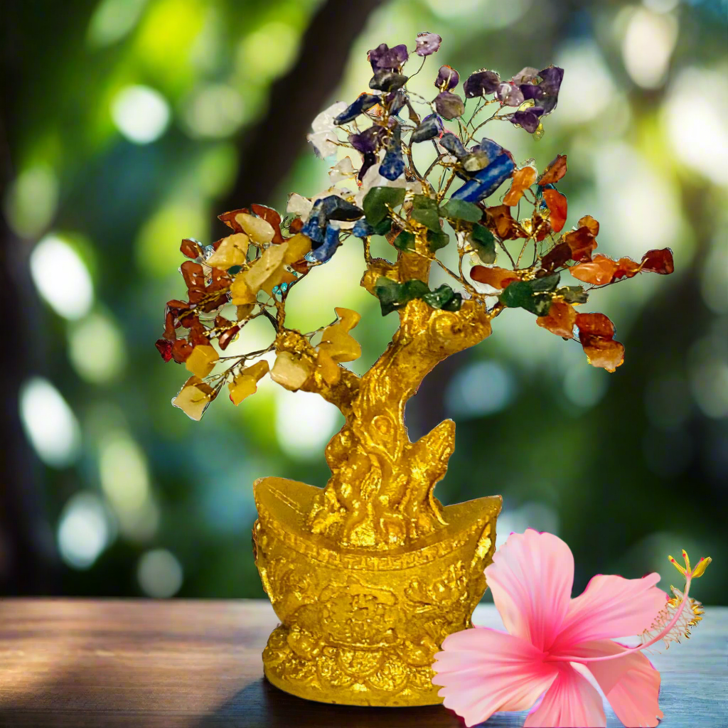 Colorful crystal tree in a gold boat  on a white background