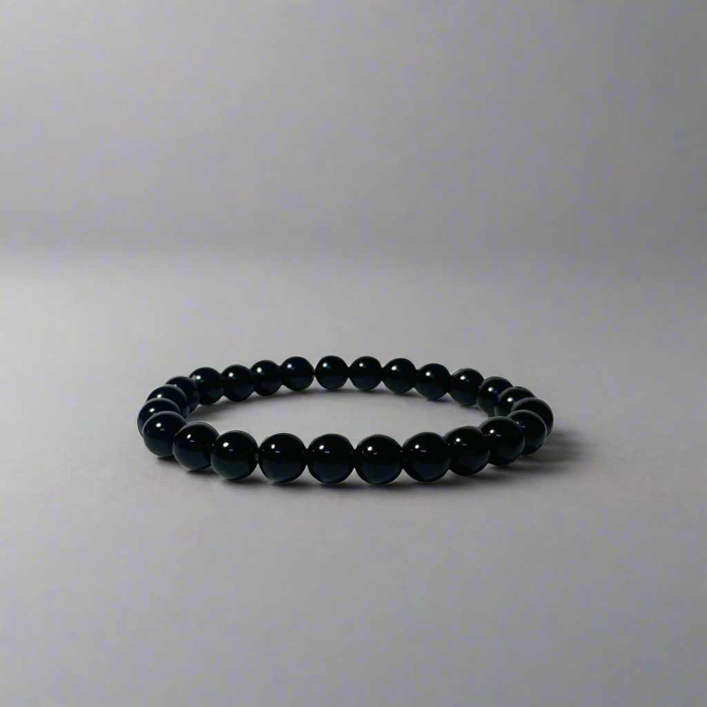Black obsidian bracelet on a light gray background