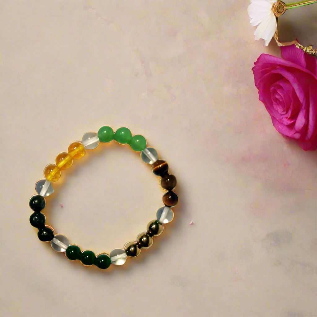 Dhan Yog bracelet on a beige surface with flowers and red fabric